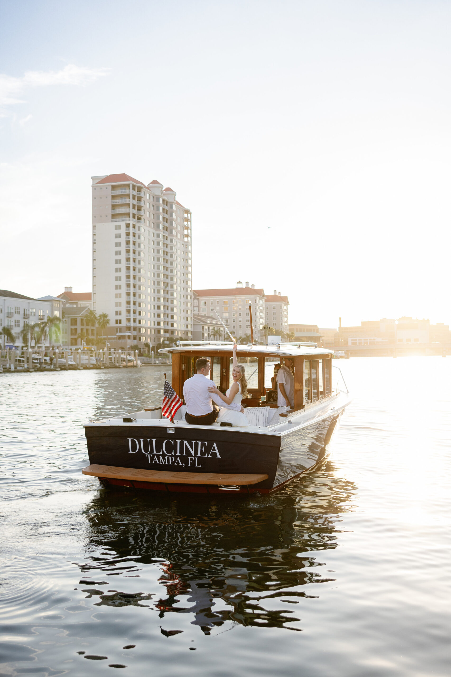 Engaged couple riding aboard the Tampa Bay Water Taxi at sunset during a waterfront engagement session in downtown Tampa